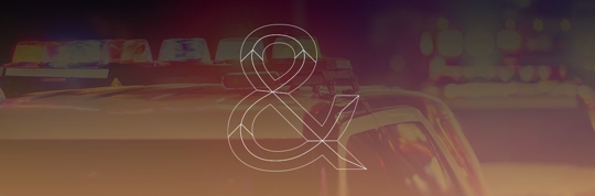 Firm Logo in front of police lights